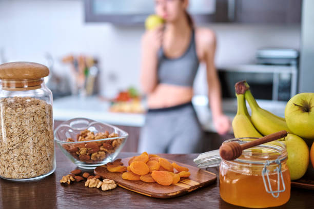 Young woman is eating an apple after a workout.