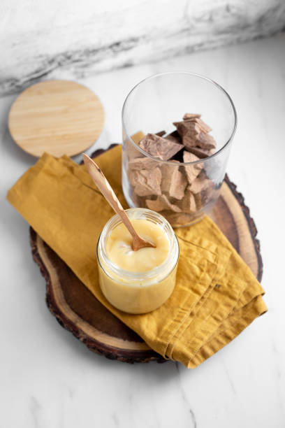 Condensed coconut milk and chocolate shavings. raw cacao mass