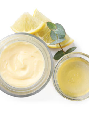 Jar of body cream with ingredients on white background, top view